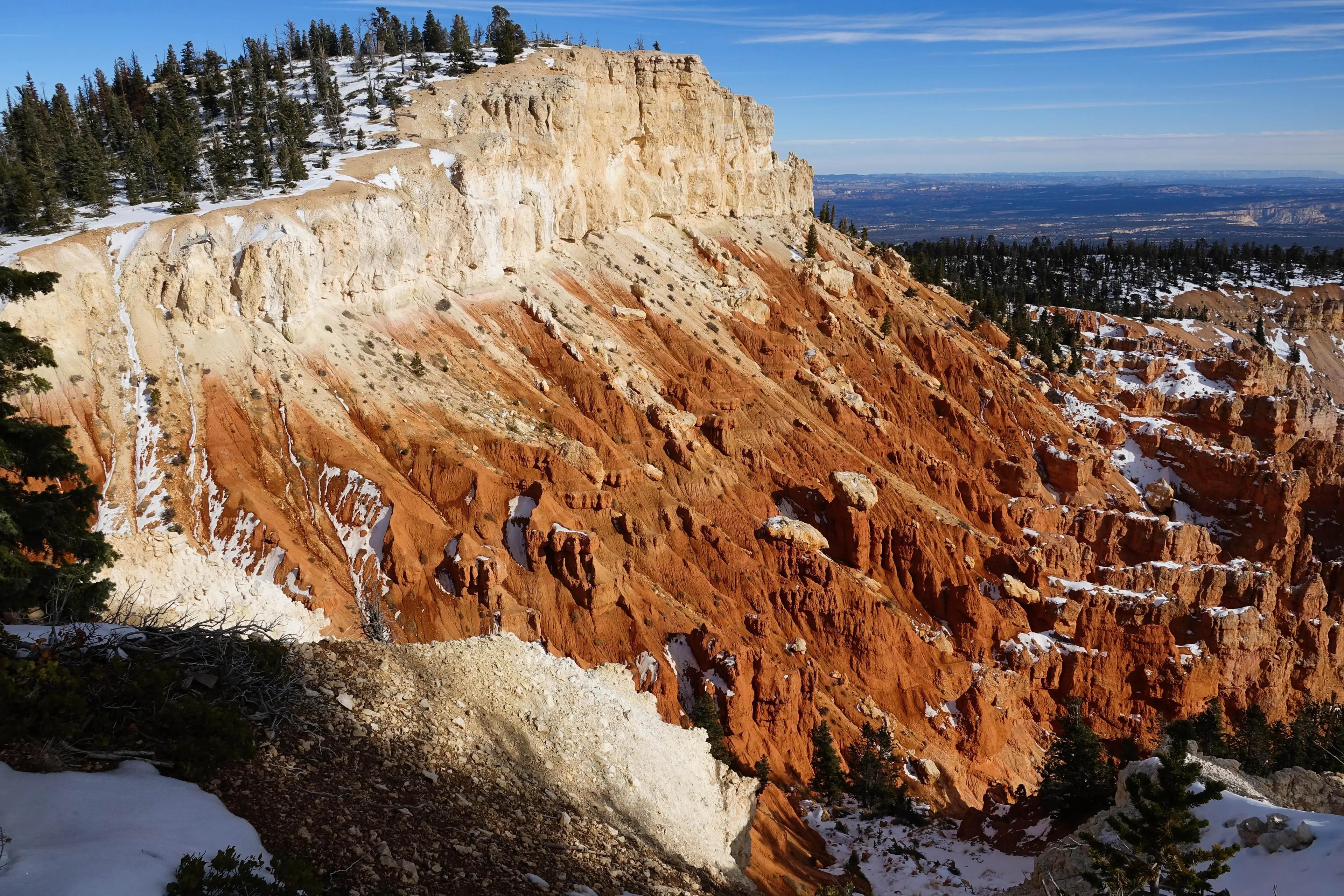 Snow-dusted red and white canyon cliffs